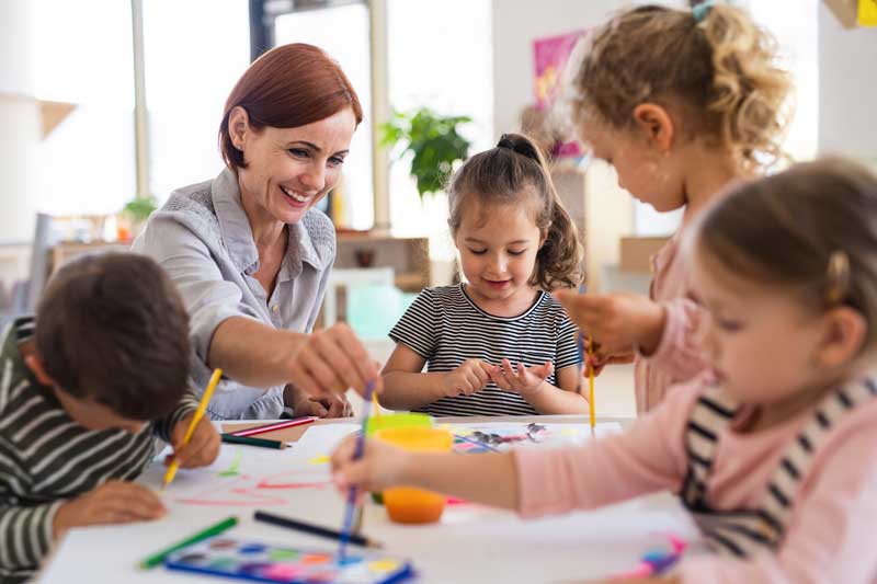 group of small nursery school children with teacher